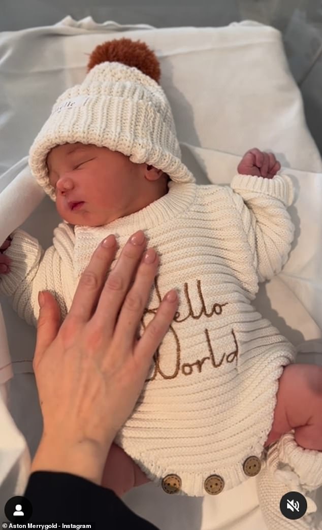 Aston shared a sweet video of her happy baby sleeping in an adorable 'Hello World' baby outfit and matching knit hat.