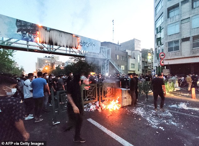 The charges were related to his song, 'Baraye', or 'For' in English, which became the national anthem in support of protests over the death of Mahsa Amini in police custody. Pictured: Iranian protesters burning a garbage container in the capital Tehran during a protest for Mahsa Amini in September 2022.