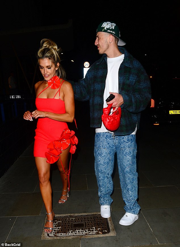 Ashley looked more in love than ever as George put his arm around her shoulder and carried her £2,000 red Bottega Veneta bag.