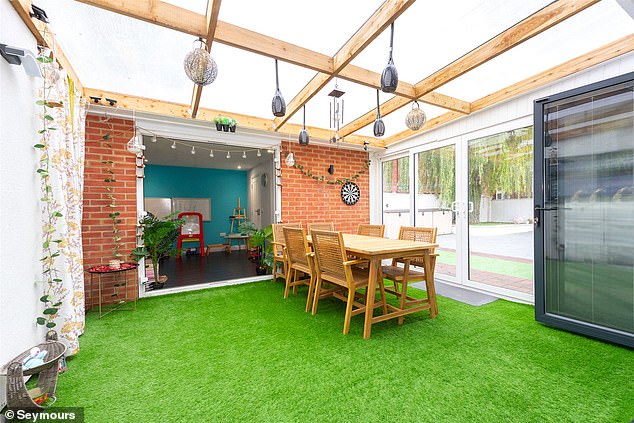 Artificial grass covers the floor of the greenhouse area