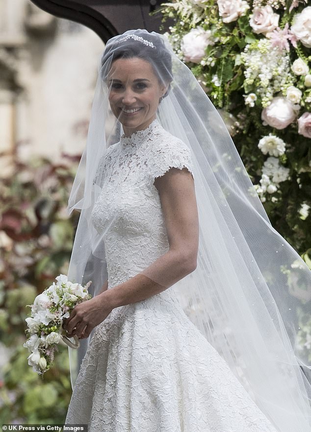 Pippa's high-neck lace wedding dress was designed by Giles Deacon