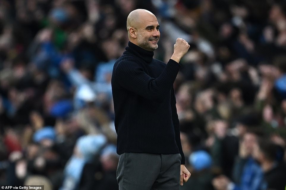 Manchester City manager Pep Guardiola pumps his fists as his team move one point behind league leaders Liverpool.