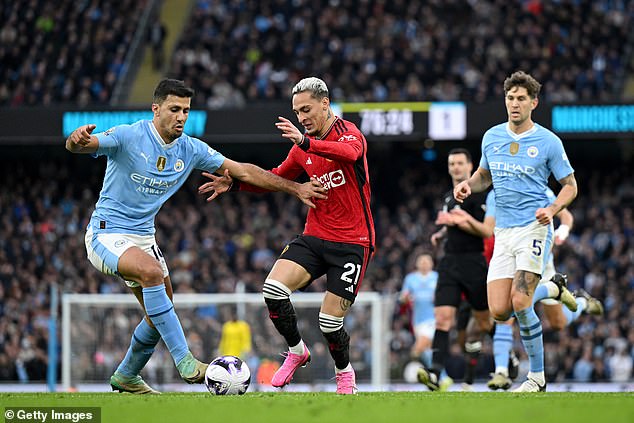 Rodri (left) produced a brilliant throw during the match, a difficult task given United's first route counter-attacking approach.