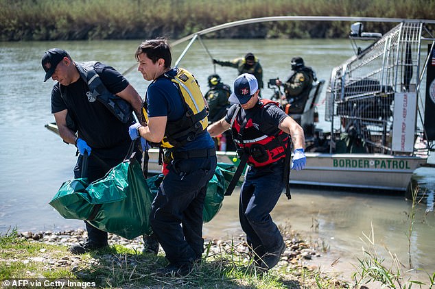 Firefighters (from left) Rodrigo Pineda, William Dorsey and Lt. Julio Valdes of the Eagle Pass Fire Department recover the body of a drowned migrant in the Rio Grande River on Friday in Eagle Pass, Texas.