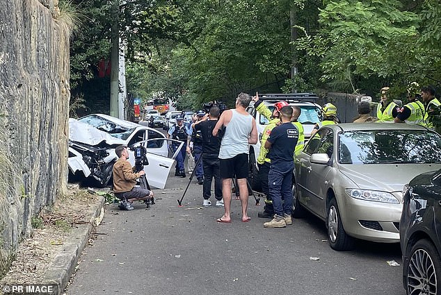 Emergency personnel appear at the scene where a car fell off a cliff in Sydney.