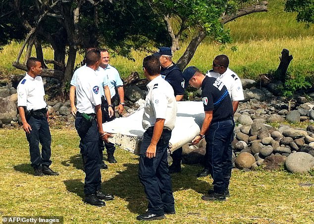 Despite extensive multinational searches in the southern Indian Ocean, where the plane is believed to have crashed, the plane disappeared without a trace and the victims' families remain desperate for answers (police are seen carrying wreckage from a plane unidentified found in the French Indian Ocean in 2015)