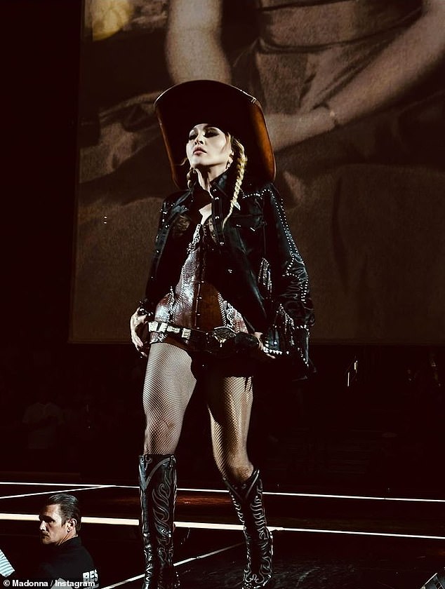 Another photo showed her strutting across the stage in a large cowboy hat, a skintight suit, and fishnet stockings that showed off her toned legs.
