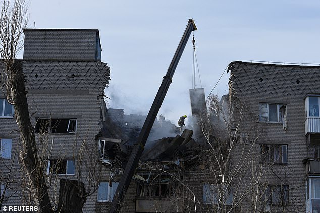 A rescuer operates at the site of an apartment building damaged by a Russian drone attack.