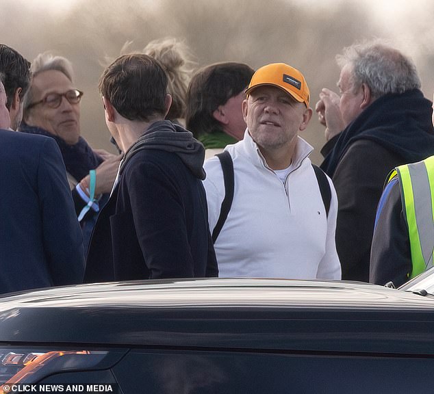 Mike Tindall was also photographed wearing a relaxed white sweatshirt, a bright orange hat and a backpack on the track.