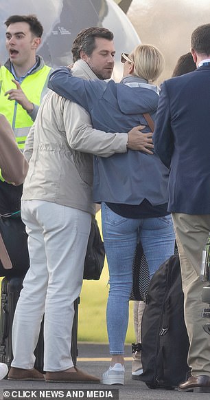Zara Tindall hugs a friend after landing in Oxford after the Behrain Grand Prix