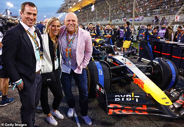 Pictured: Mike and Zara Tindall pose with Peter Phillips next to Max Verstappen's winning car at the Grand Prix.