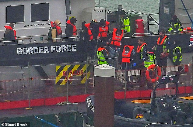 Dozens of migrants were brought ashore Thursday at the port of Dover after battling thick fog to cross the English Channel.