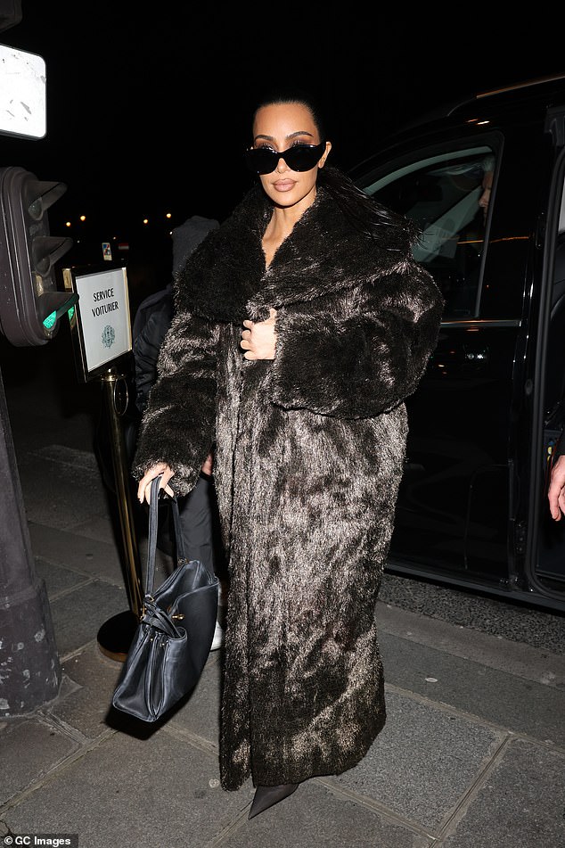 Kim radiated glamor as she was photographed entering later that night.