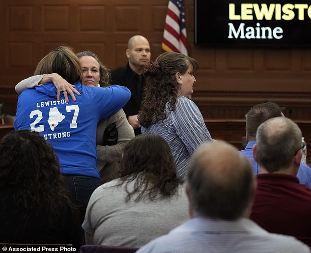 Shooting survivor Danielle Grondin hugs fellow shooting survivor Tammy Asselin, wearing a 'Lewiston Strong' T-shirt, before a public meeting with a commission investigating the October 2023 shootings, Monday, March 4, 2024, in Lewiston, Maine.