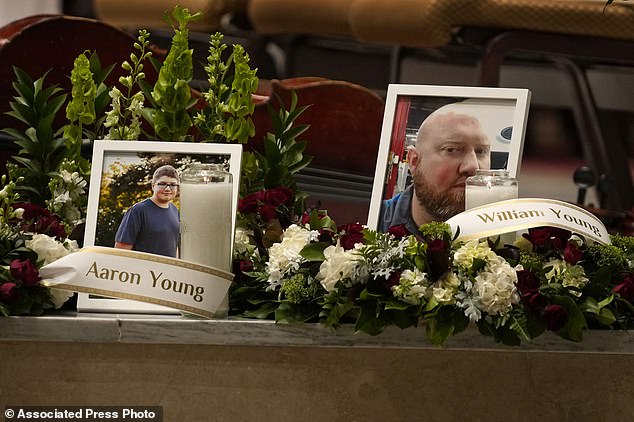 Photos of Aaron Young and his father, William Young, are shown at a vigil for the victims of Wednesday's mass shootings at the Basilica of Saints Peter and Paul, Sunday.