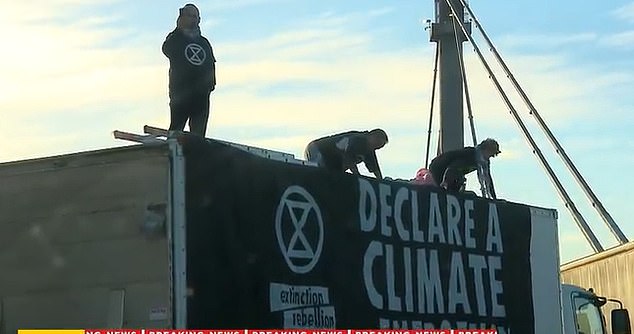 Protesters climbed onto a truck that was blocking three lanes of traffic in the city.