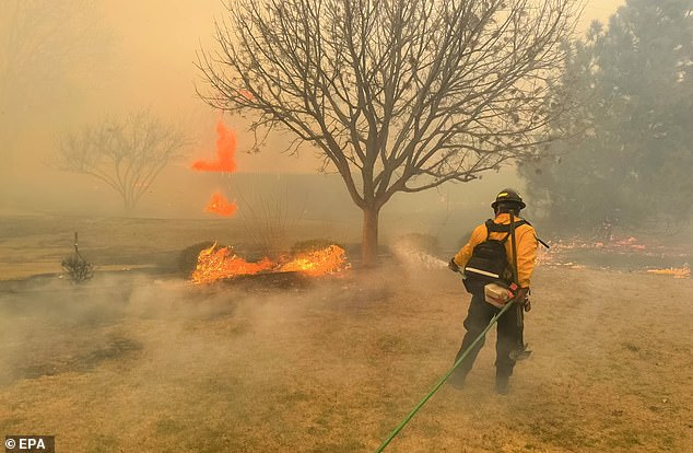 Firefighters from the Flower Mound Fire Department help contain a wildfire in the Texas Panhandle region.