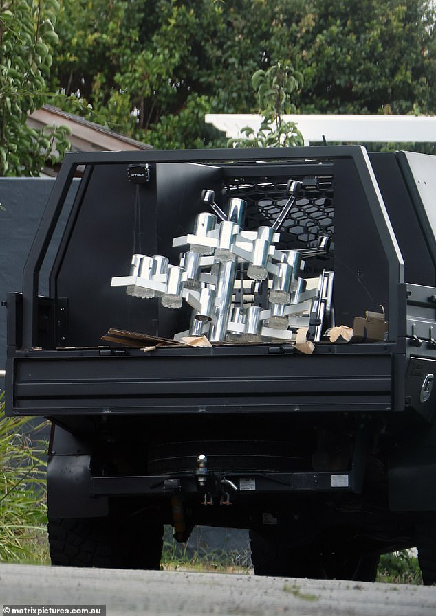 A large modernized silver chandelier and what appeared to be an office chair were loaded into the back of Max's ute.