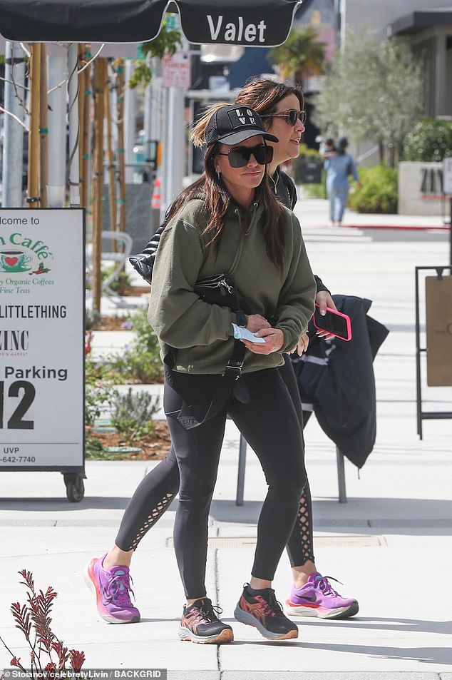 The Real Housewives of Beverly Hills star, 55, sported an olive green hoodie, black tights, black sneakers and a trucker cap with the word 'Love' embroidered on it.