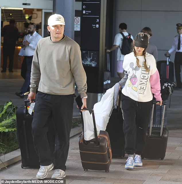Landing in Sydney after the shindig, Cooper cut a relaxed figure in black tracksuit bottoms and a gray jumper, which he teamed with a cream cap.