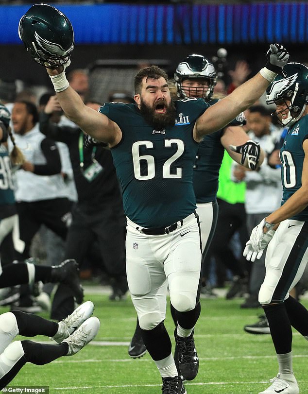 Kelce raises his arms after winning the Super Bowl with Philadelphia in 2018 against the Patriots