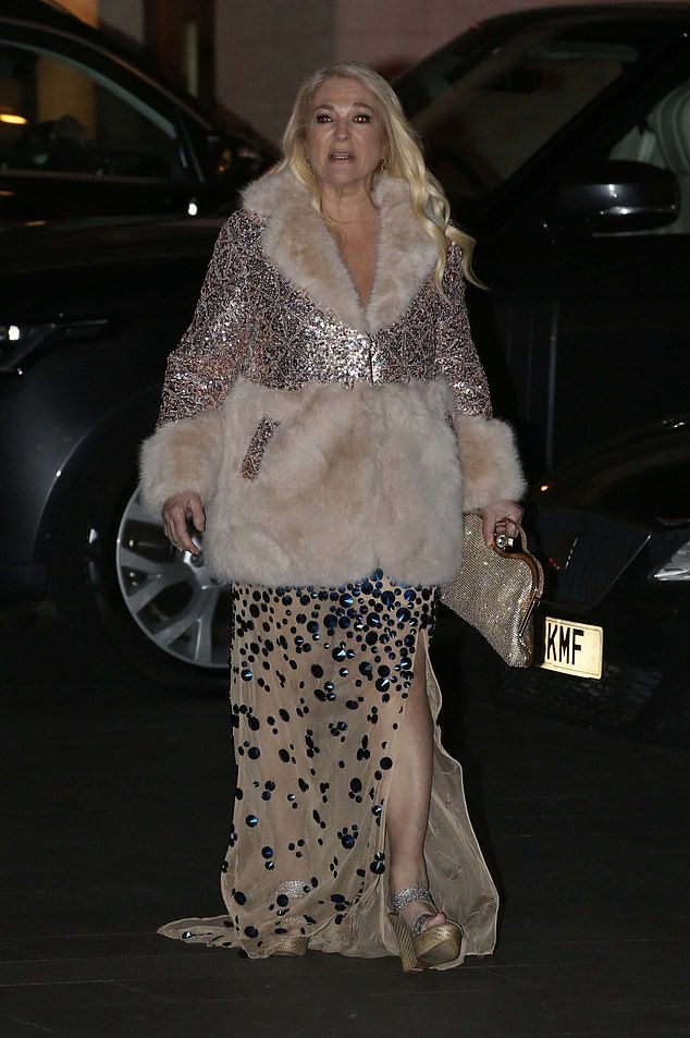 Her dress was embellished with silver sequins as she left the charity event, wrapped in a cozy white fur-lined jacket.