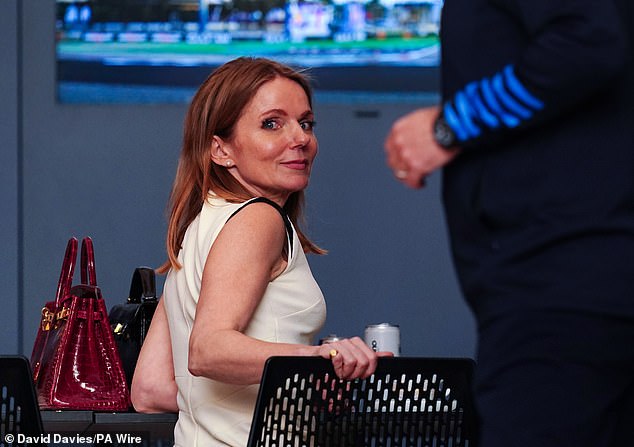 After kissing, Geri appeared to look directly at the photographers.