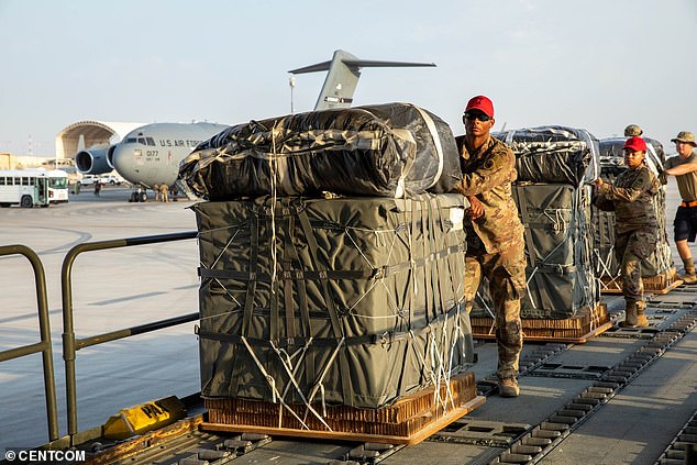 U.S. Army soldiers are shown moving packaged aid packages Tuesday morning.