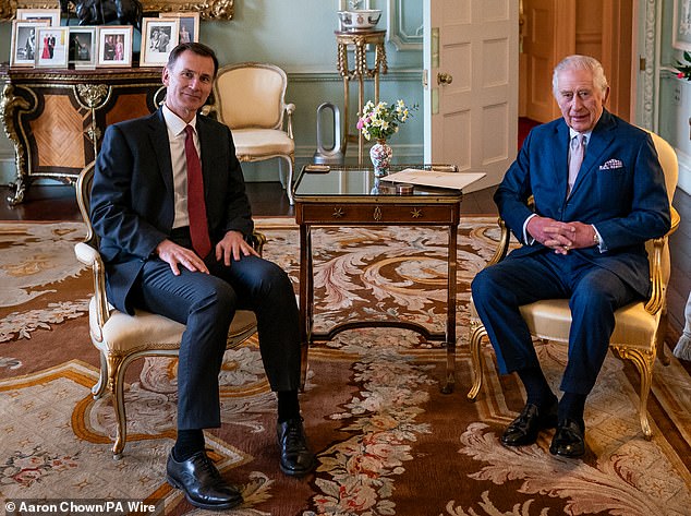 King Charles is pictured with Chancellor Jeremy Hunt at Buckingham Palace in London today.