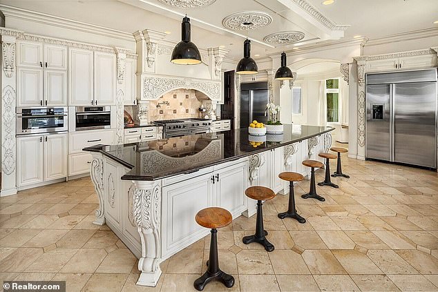 The giant kitchen has a huge center island and space to host large dinner parties.