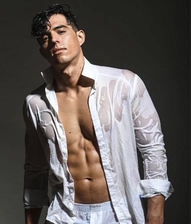 Flores is seen soaked in water while modeling a white button-down shirt and matching boxers.