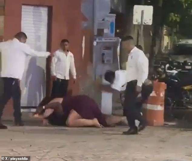A woman lies on top of her partner as Mexican taxi drivers beat the couple after they confronted a driver over a taxi fare they thought was exorbitant.
