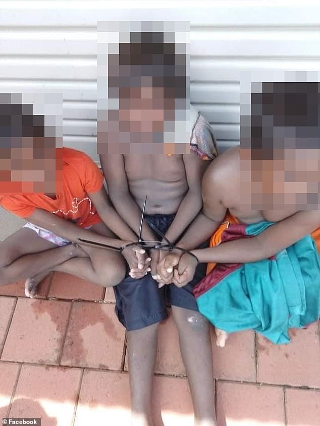 The children appear tied up in a photo posted on Facebook (pictured)