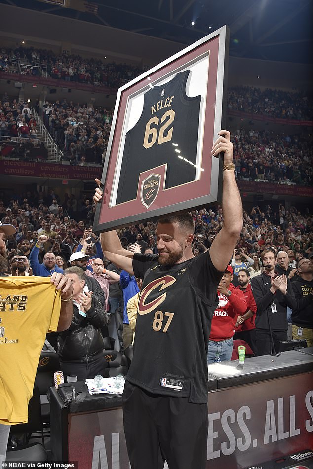 Travis proudly held a framed Cavs jersey with the number 62 on his brother Jason's other one.