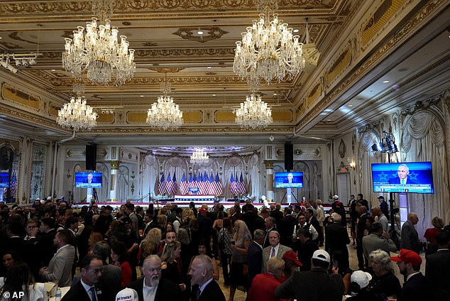 The party took place amid the gilded opulence of Mar-a-Lago's Grand Ballroom, where 16 chandeliers hang from the ceiling and the walls sparkle with mirrors.