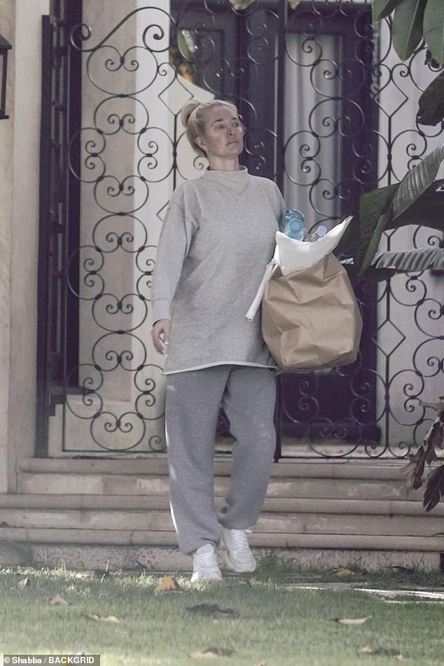 On another occasion he appeared more casual, wearing a gray sweater and matching sweatpants, along with white sneakers.