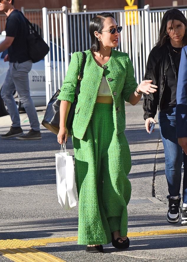The 42-year-old showed off her abs in a crop top underneath an oversized green jacket and matching set of pants.