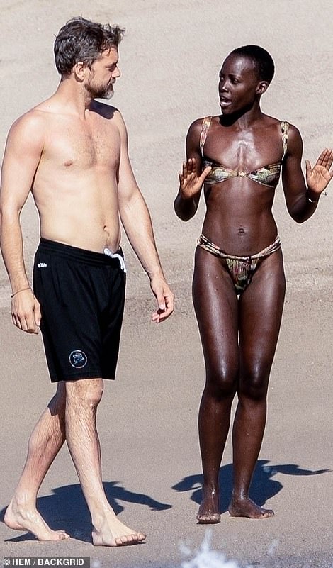 1709708958 70 Joshua Jackson passionately embraces his bikini clad girlfriend Lupita Nyongo on