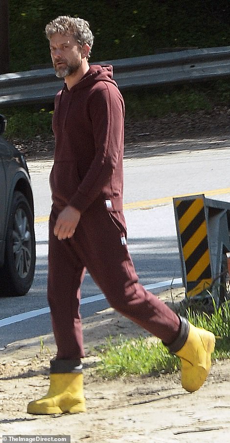 Joshua kept it casual in a reddish-brown tracksuit paired with yellow rubber boots with black trim.