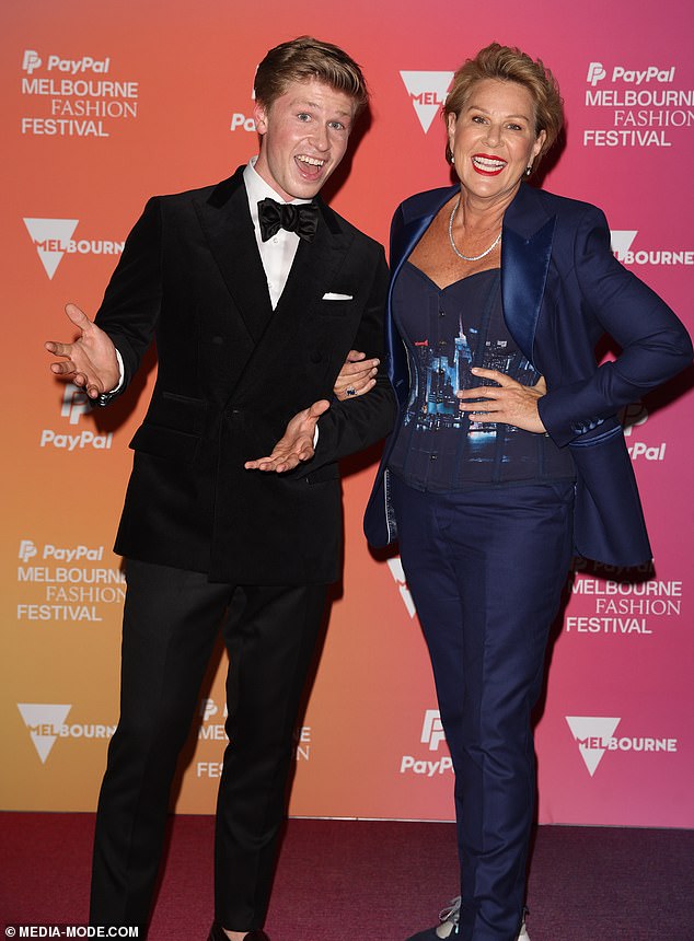 Also present was Robert Irwin, 20, who channeled his inner James Bond in a dapper tuxedo as he made his runway debut. He appeared to be having the time of his life as he posed for photos on the red carpet alongside his I'm a Celebrity... Get Me Out of Here co-host Julia Morris, 55. Both in the photo.