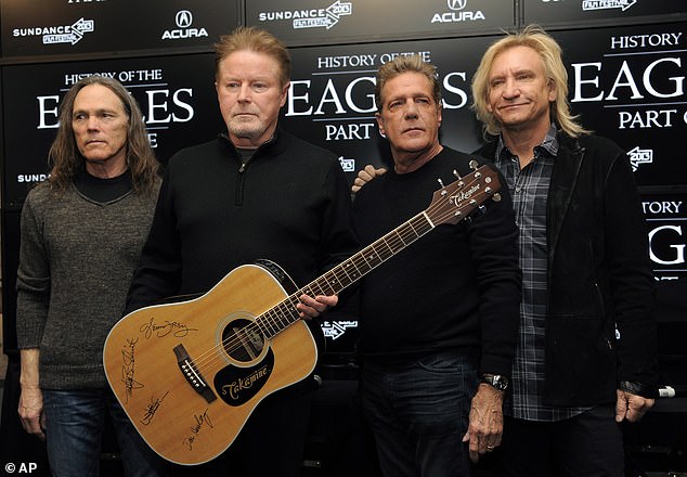 The Eagles members, from left, Timothy B. Schmit, Don Henley, Glenn Frey and Joe Walsh pose with an autographed guitar after a press conference in 2013.