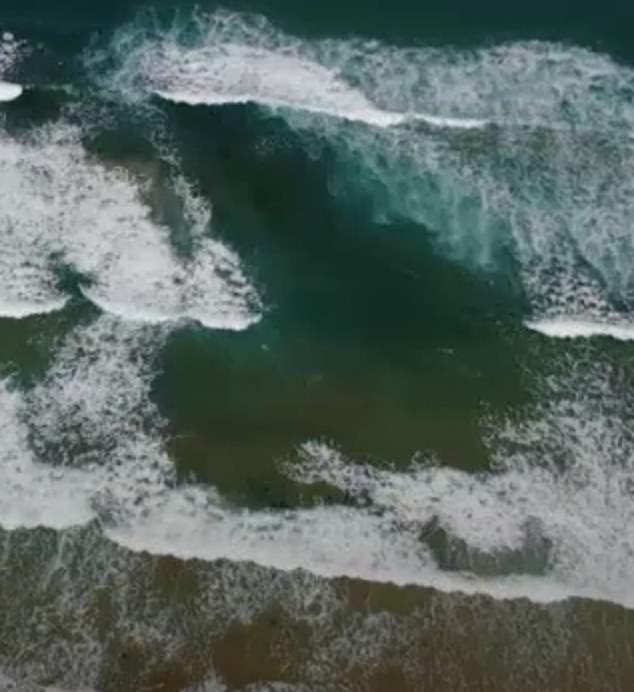 Rips are the number one hazard on Australian beaches and can be difficult to detect. However, key signs of a break include fewer breaking waves, gaps between waves, and deep, dark water (pictured).