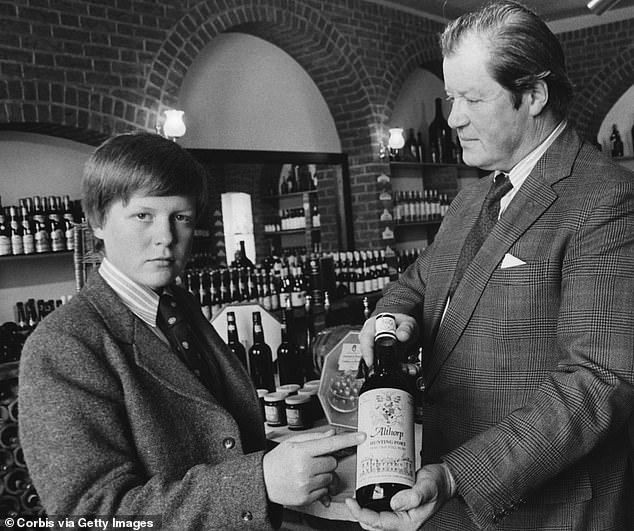 Charles is pictured with his father, the 8th Earl Spencer, in the estate's cellars.