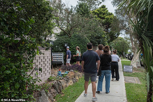 Prospective tenants appear in a long line to view an open property inspection