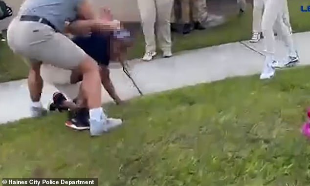 The woman soon breaks free and begins throwing punches at a student lying on the ground.