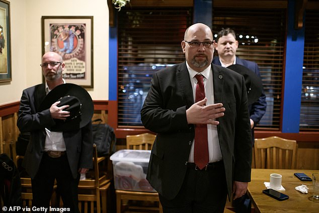 Texas Nationalist Movement Chairman Daniel Miller leads a Pledge of Allegiance at a barbecue restaurant in Cypress, Texas.