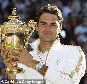 Tennis superstar Roger Federer photographed in 2009 holding the Wimbledon trophy.