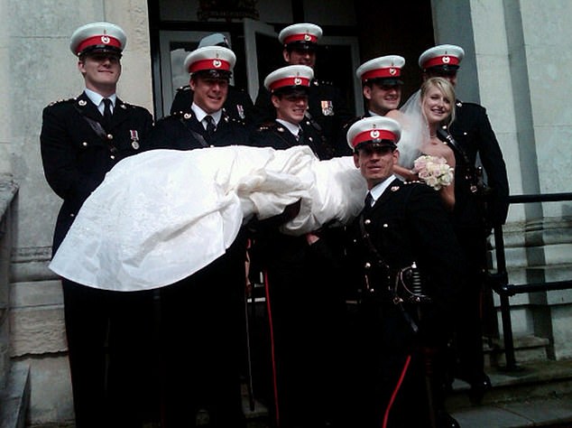 Pictured: Stephanie posed with half a dozen members of White's regiment holding her in their arms as she lay horizontally outside the church.