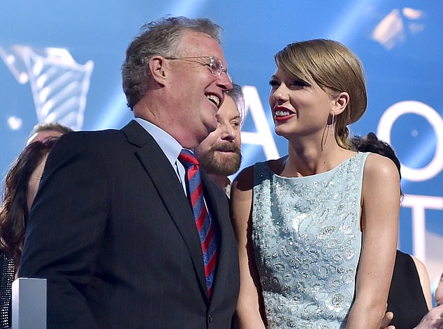 Taylor Swift's father Scott (pictured with her in 2015) has been steadfastly by her side throughout her tour. But he has been charged with assault after a run-in with paparazzi in Australia.