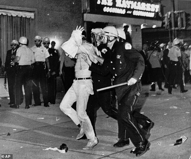 Tear gas was fired into the crowd. The officers indiscriminately beat the protesters. Hundreds of people were sent to hospital and even more were injured. (Above) A protester with his hands on his head is led by Chicago police down Michigan Avenue on the night of August 28, 1968.